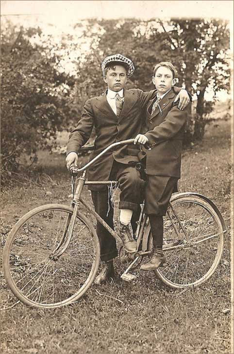 vintage photo of two boys, on vintage bicycle, male affection, gay